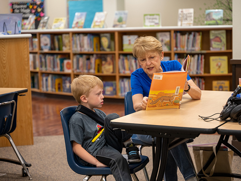 Diane Sterett reading to kindergartener Henry Stegemann